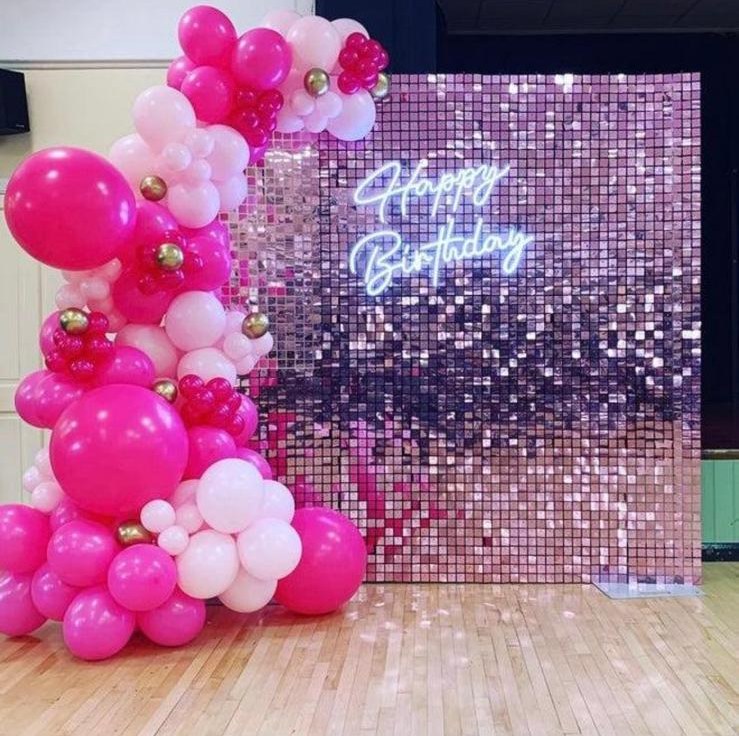 Pink shimmer wall birthday backdrop with balloon garland