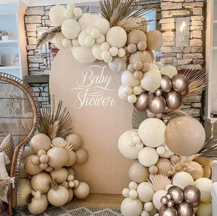 Baby shower backdrop with sign and balloon arrangement